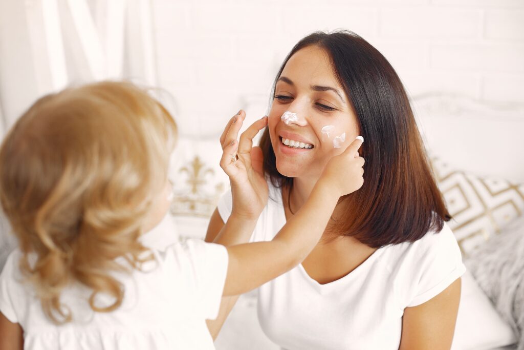 Mom applying moisturizer as part of her daily skincare routine