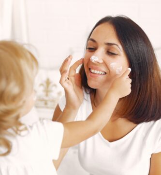 Mom applying moisturizer as part of her daily skincare routine