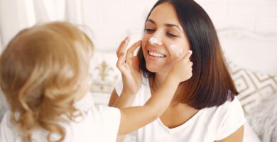 Mom applying moisturizer as part of her daily skincare routine