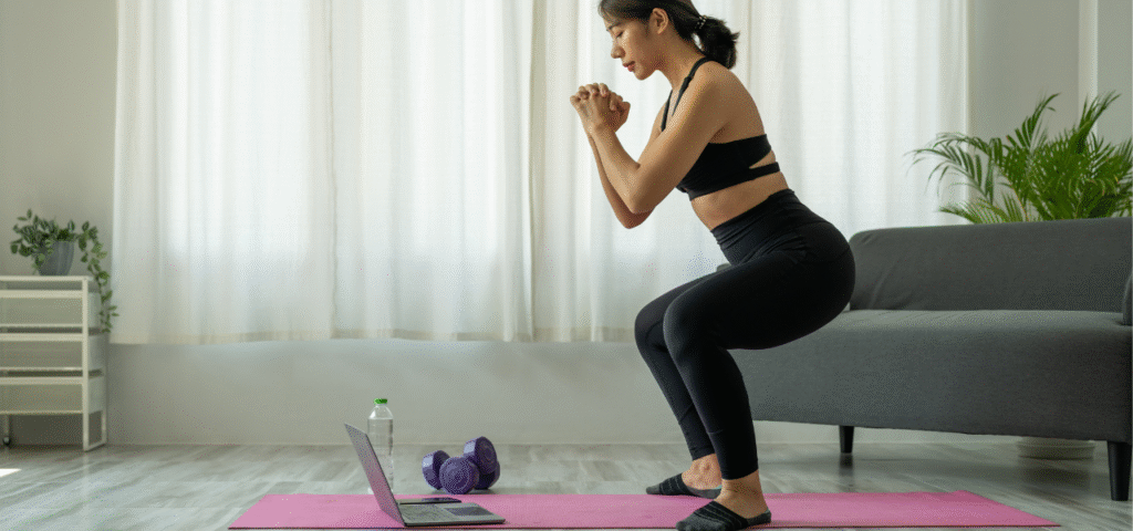 Woman doing air squats during a home workout routine