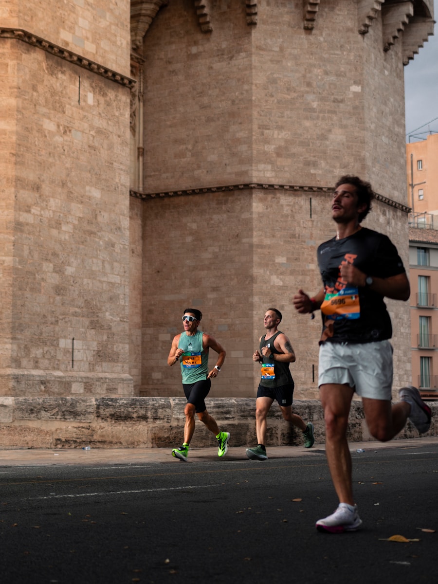 Three men running a race past a stone building